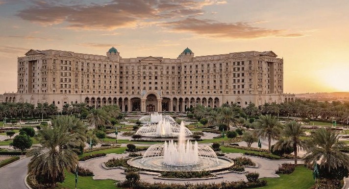 Palace hotel with fountains at sunset